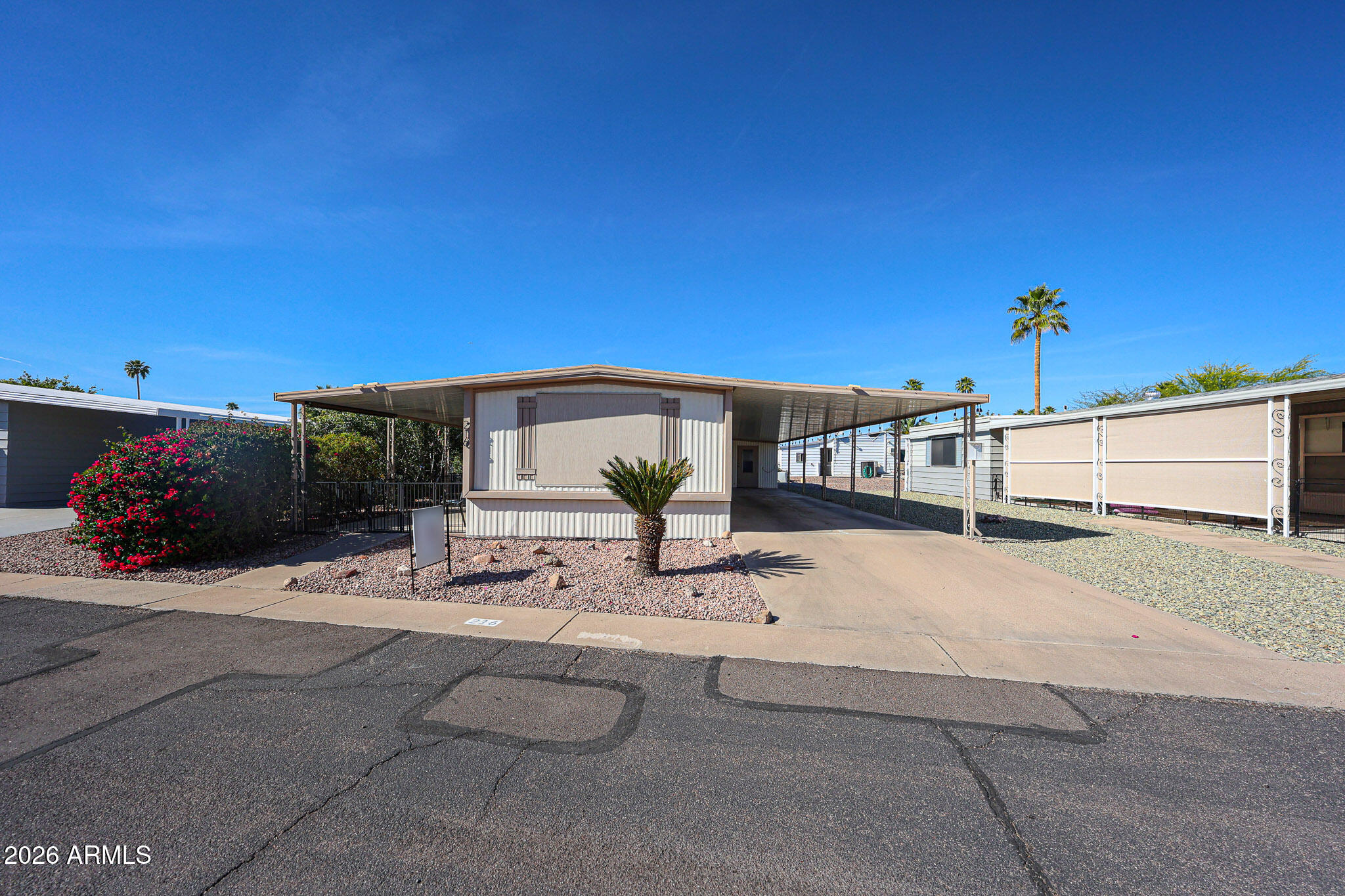 3104 East Broadway Road, Unit 216 Mesa, AZ 85204 - Photo 1 of 37 a view of a patio with a table and chairs under an umbrella