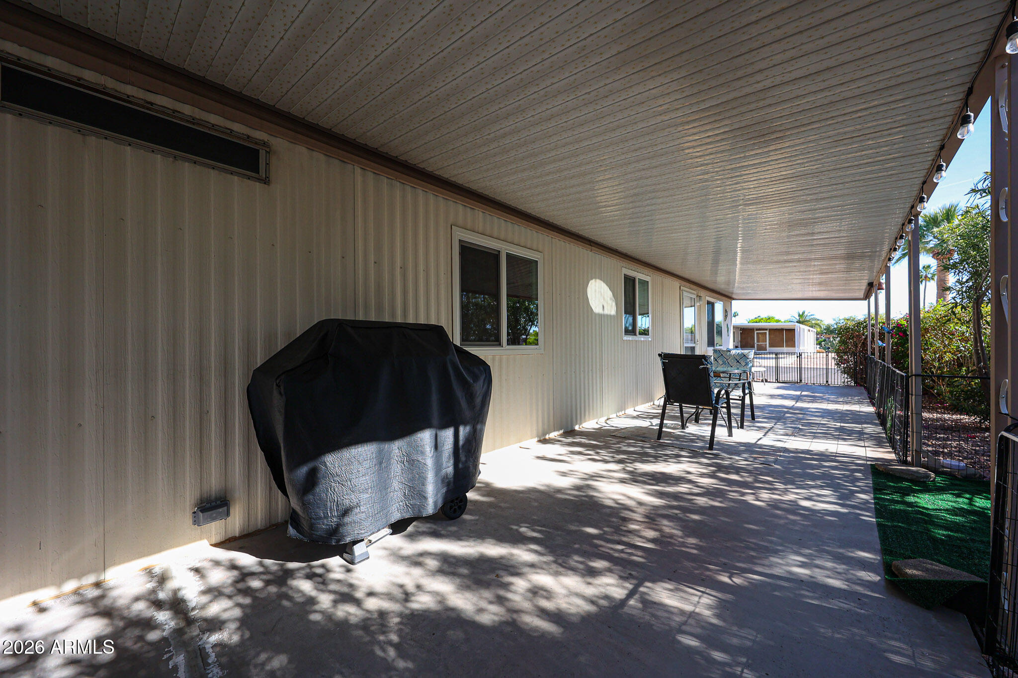 3104 East Broadway Road, Unit 216 Mesa, AZ 85204 - Photo 35 of 37 a view of backyard with a table and chairs and potted plants