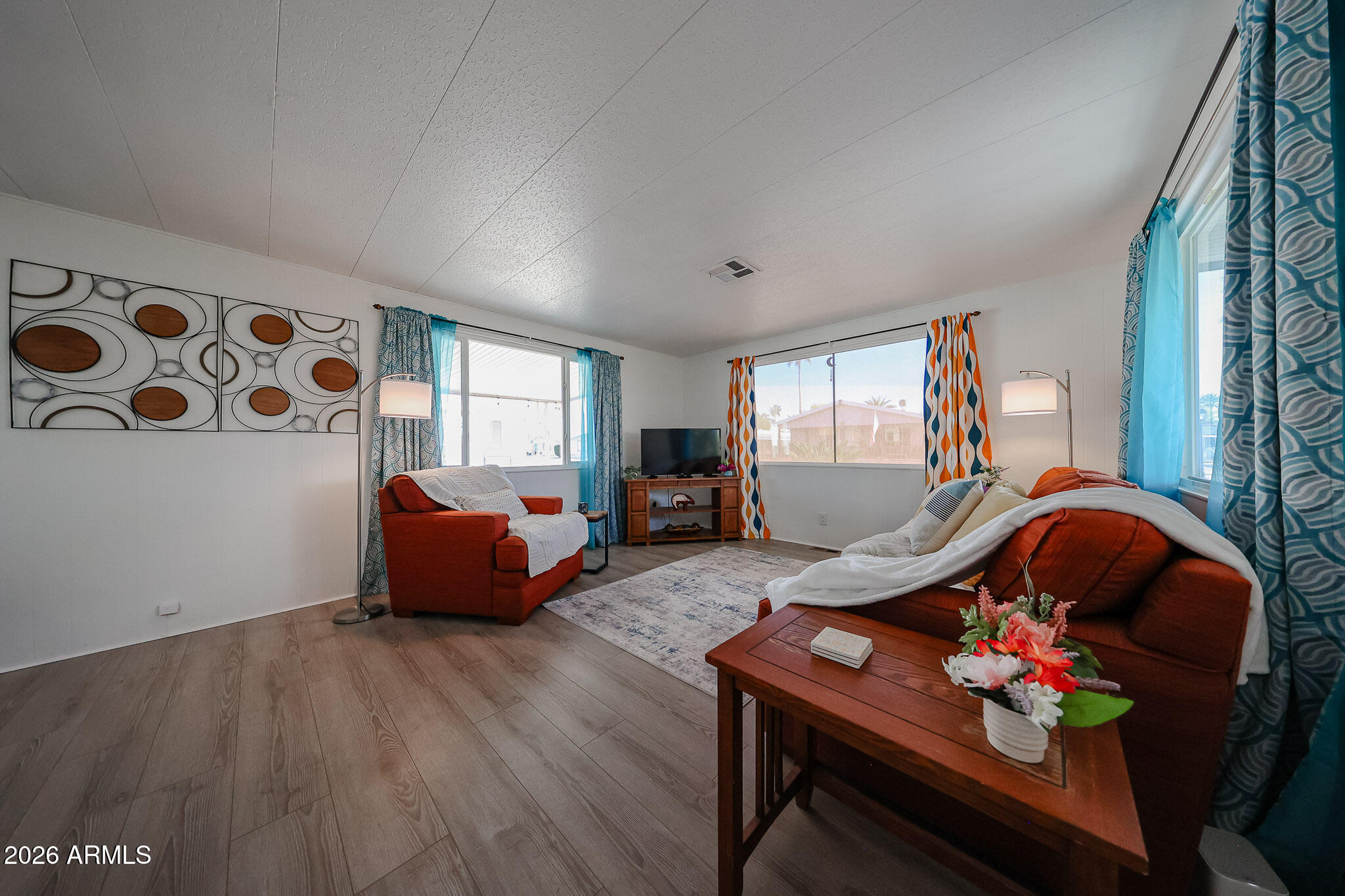 3104 East Broadway Road, Unit 216 Mesa, AZ 85204 - Photo 5 of 37 a living room with furniture and wooden floor