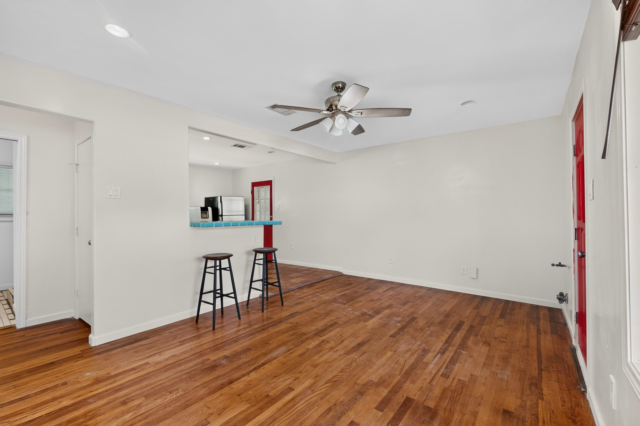 4711 Alf Avenue Austin, TX 78721 - Photo 6 of 34 Hardwood floors and a breakfast bar connect living to kitchen in this inviting space.