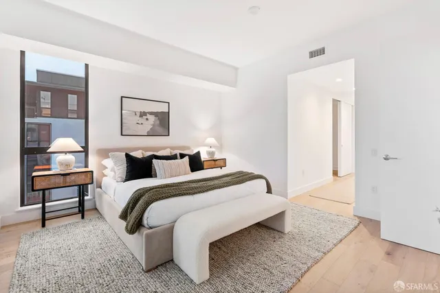 a bedroom with bed and a night stand