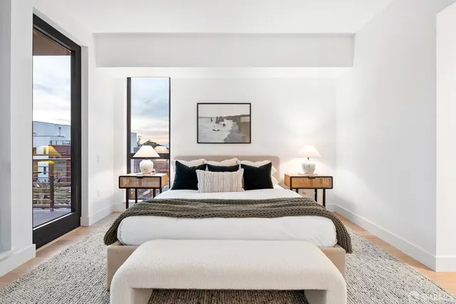 a bedroom with a large bed and a window