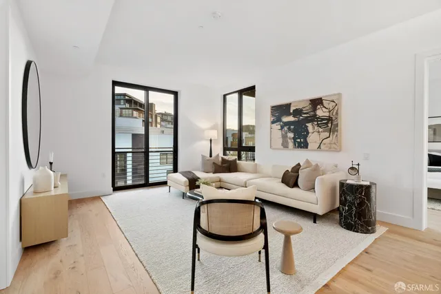 a living room with furniture and a floor to ceiling window