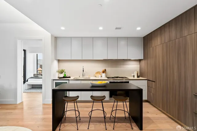a kitchen with granite countertop a sink and cabinets