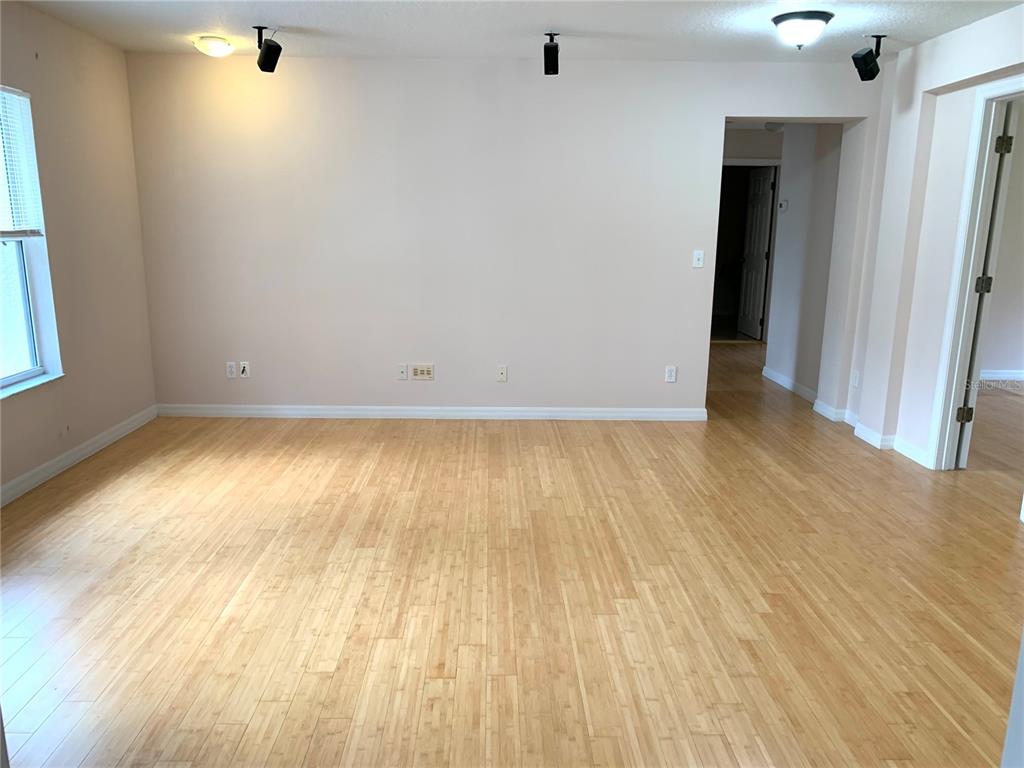 963 North Jacks Lake Road Clermont, FL 34711 - Photo 15 of 39 an empty room with wooden floor and windows