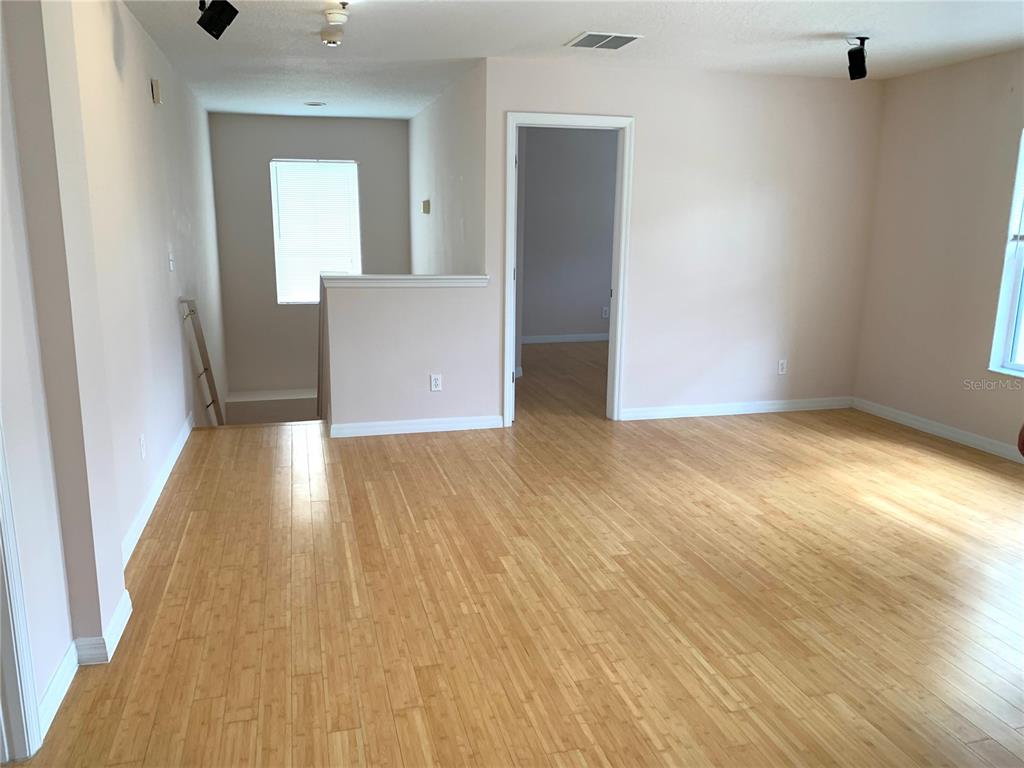 963 North Jacks Lake Road Clermont, FL 34711 - Photo 16 of 39 wooden floor in an empty room with a window
