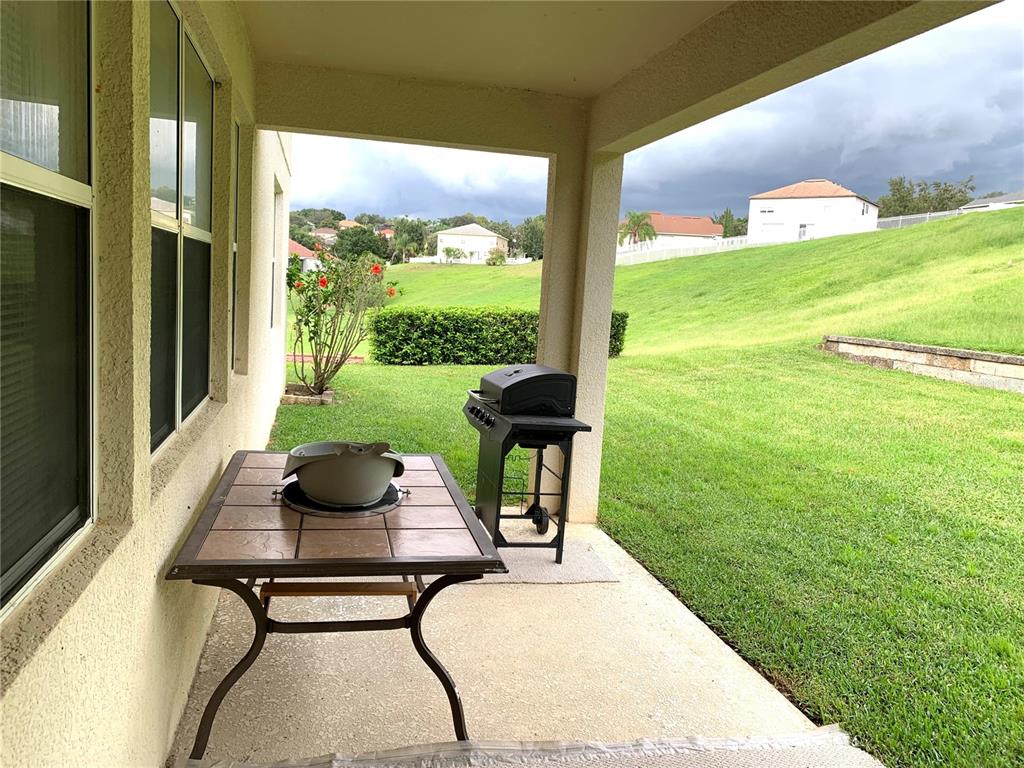 963 North Jacks Lake Road Clermont, FL 34711 - Photo 21 of 39 a view of a porch with furniture and garden