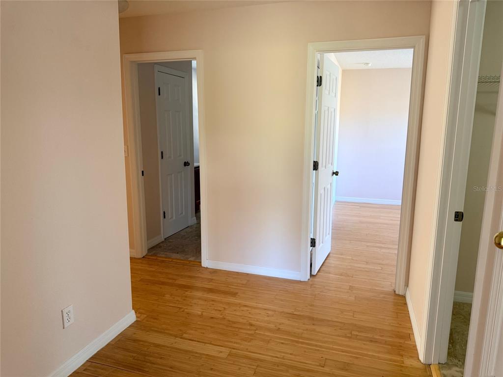 963 North Jacks Lake Road Clermont, FL 34711 - Photo 28 of 39 a view of a hallway with wooden floor