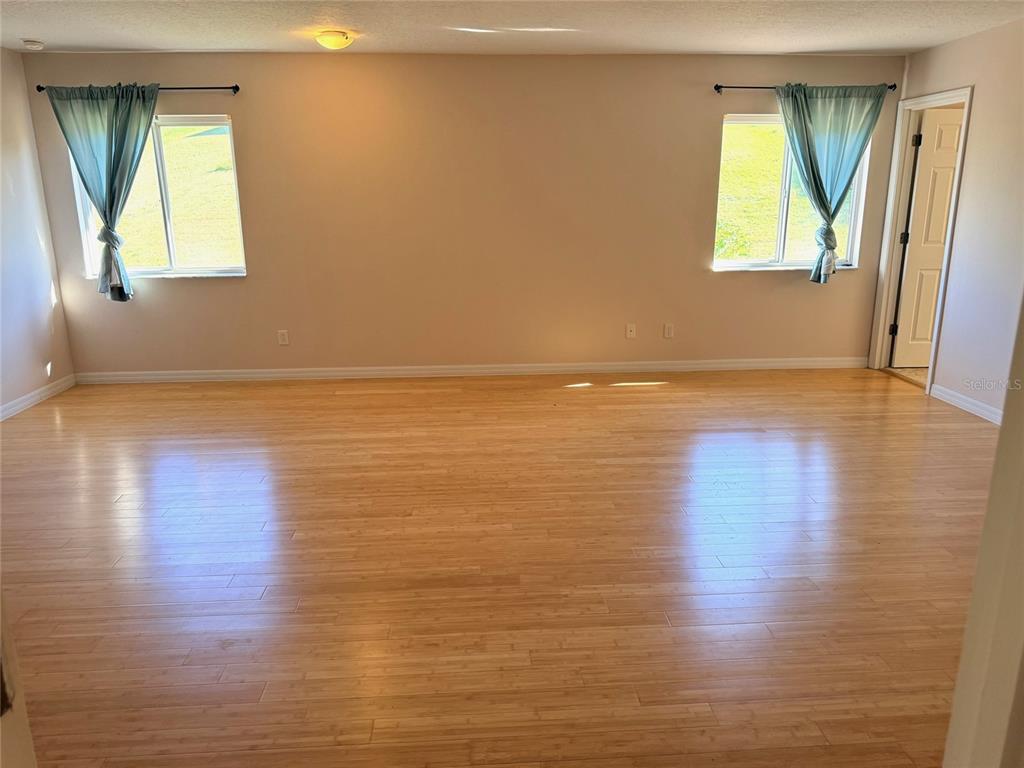 963 North Jacks Lake Road Clermont, FL 34711 - Photo 33 of 39 a view of empty room with wooden floor and fan