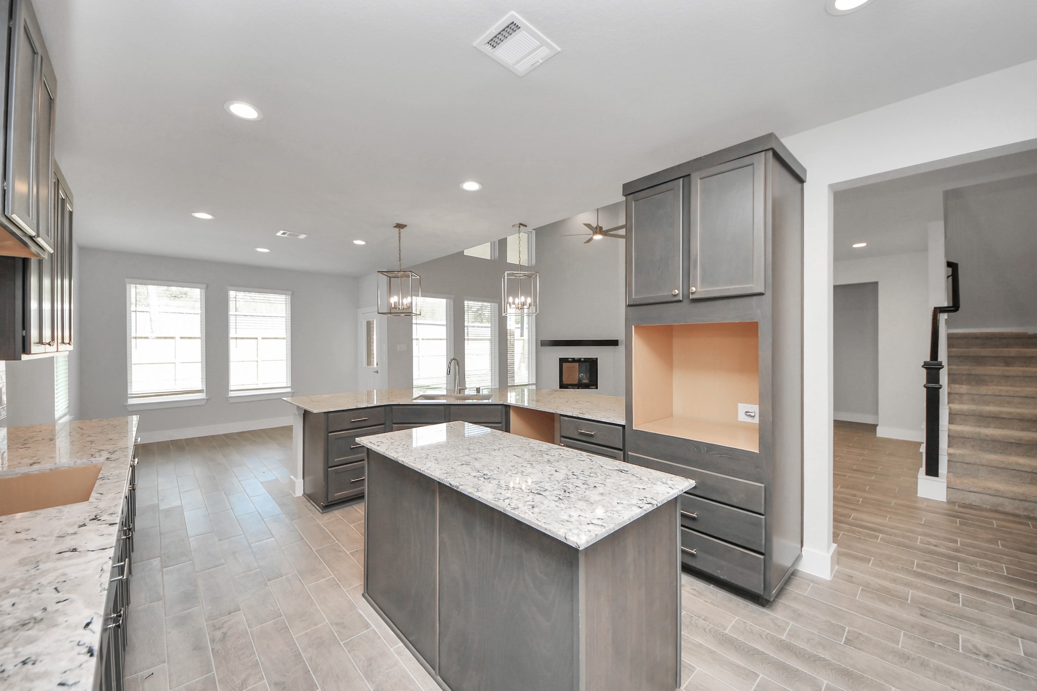 3110 Native Spg Drive Spring, TX 77373 - Photo 9 of 34 This generously spacious kitchen is a dream realized! With a massive granite island, high ceilings, soft close cabinets, granite countertops, stainless steel appliances, a sleek tile backsplash, recessed lighting, and an extended counter area, it offers both style and practicality. All this opens up to the expansive family room, creating a perfect hub for gatherings. Sample photo of completed home with similar floor plan. Actual colors and selections may vary.