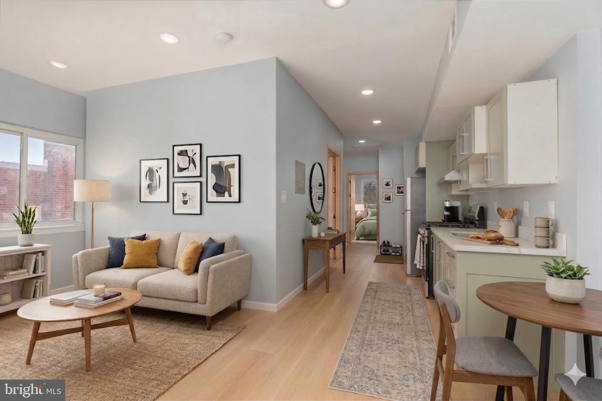 a living room with furniture and kitchen view