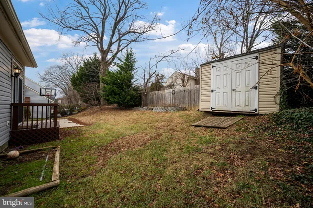 a view of a house with a yard covered in snow