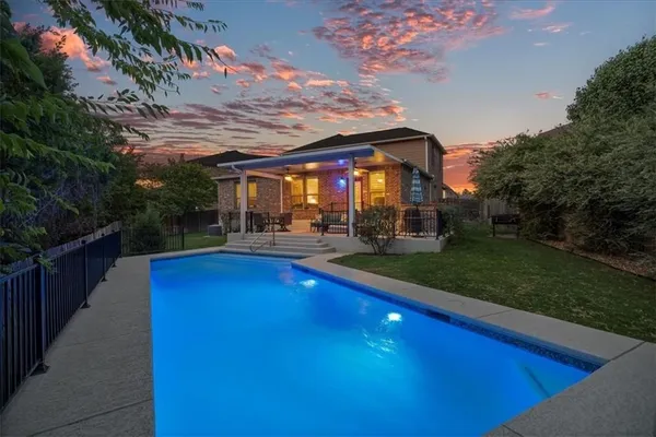 a view of a swimming pool with a patio