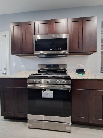 935 West Marquette Road, Unit 3 Chicago, IL 60621 - Photo 12 of 25 a kitchen with wooden cabinets and stainless steel appliances