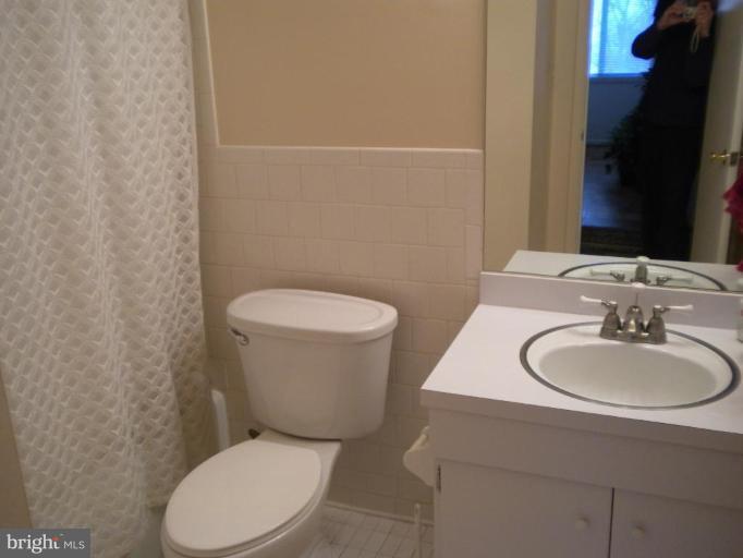 200 Cross Keys Road, Unit 58 Baltimore, MD 21210 - Photo 11 of 11 a white toilet sitting next to a bathroom sink