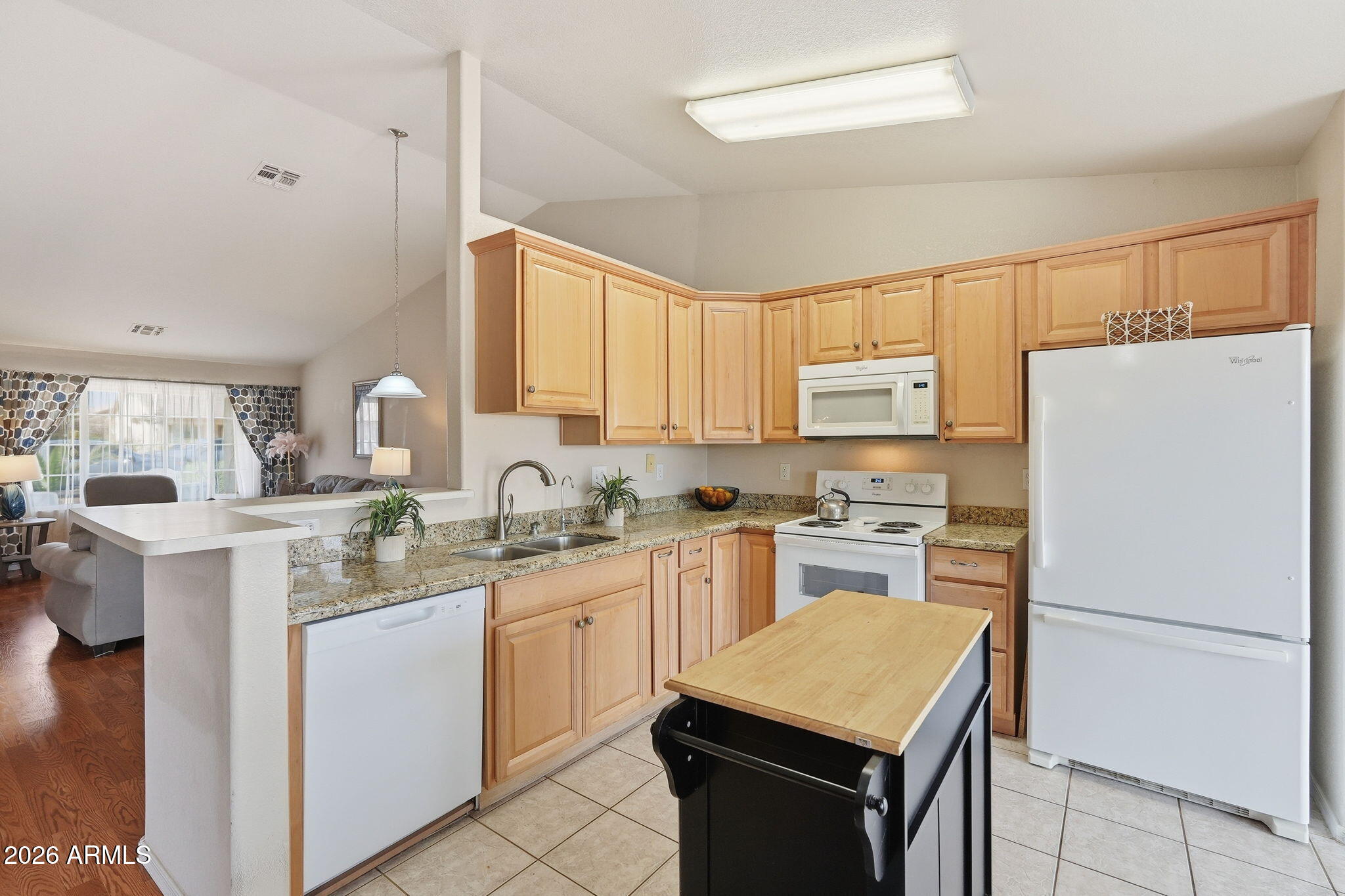 1405 West 15th Lane Apache Junction, AZ 85120 - Photo 12 of 33 a kitchen with a sink a stove a refrigerator a center island and a window