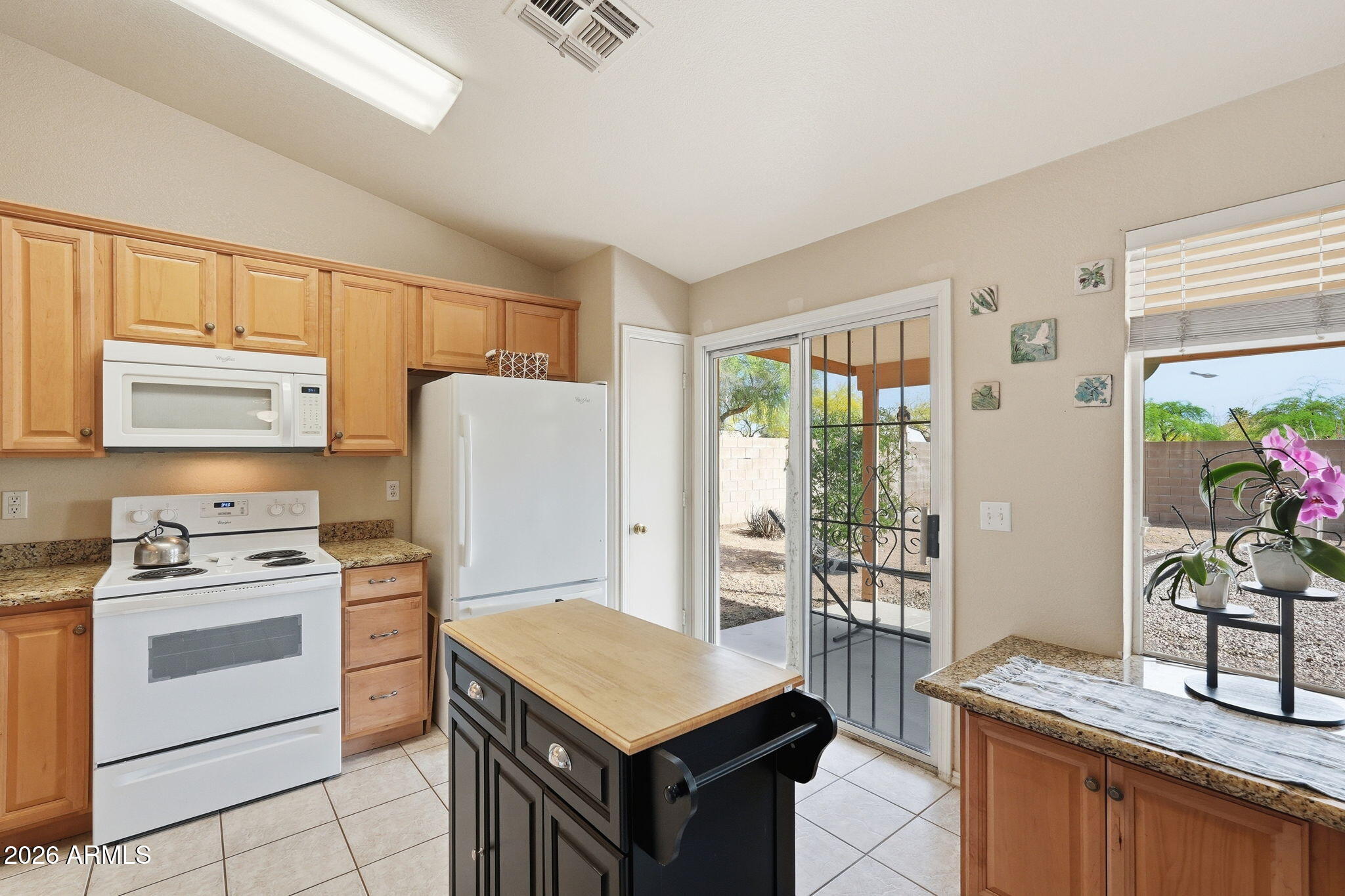 1405 West 15th Lane Apache Junction, AZ 85120 - Photo 14 of 33 a kitchen with a stove a sink and a refrigerator