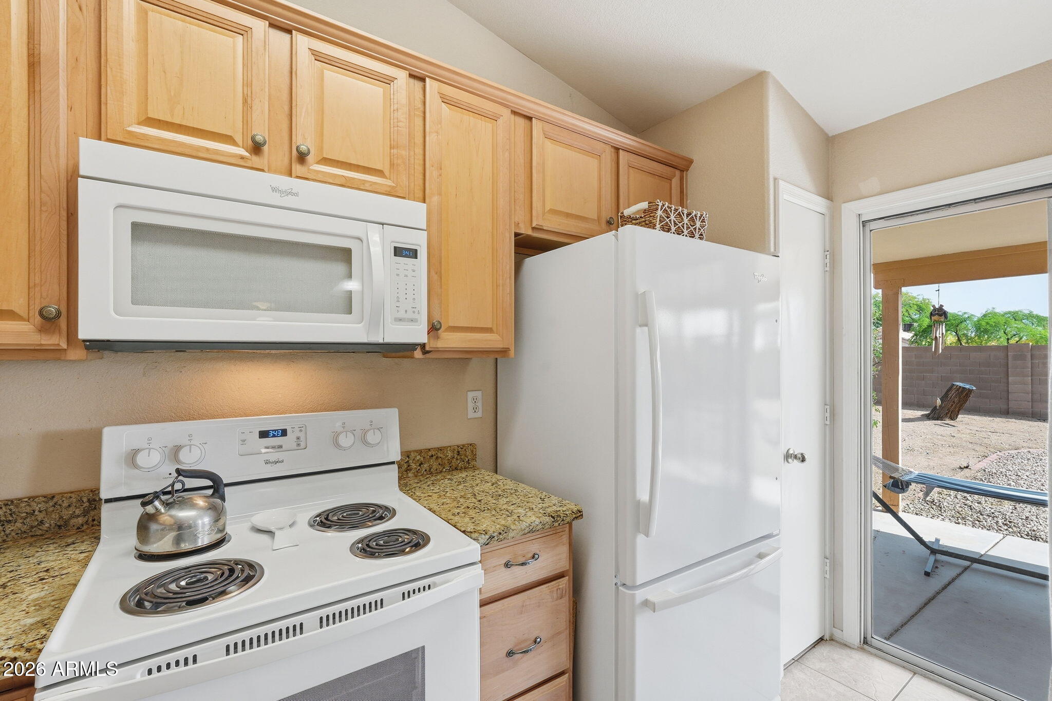 1405 West 15th Lane Apache Junction, AZ 85120 - Photo 15 of 33 a kitchen with a stove and a white refrigerator