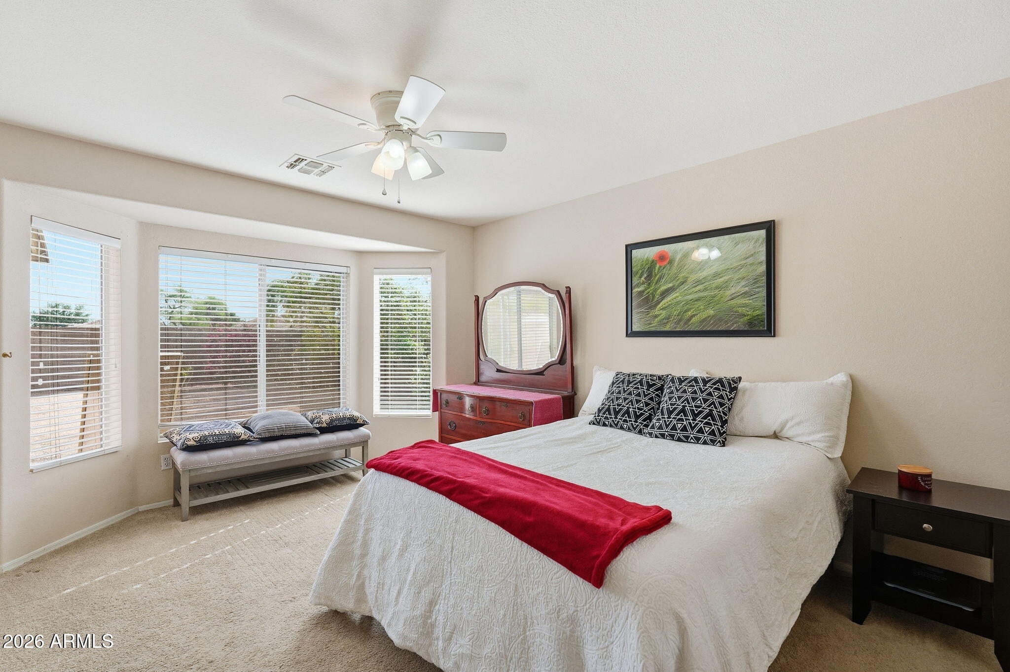 1405 West 15th Lane Apache Junction, AZ 85120 - Photo 17 of 33 a bedroom with a bed a couch and dresser