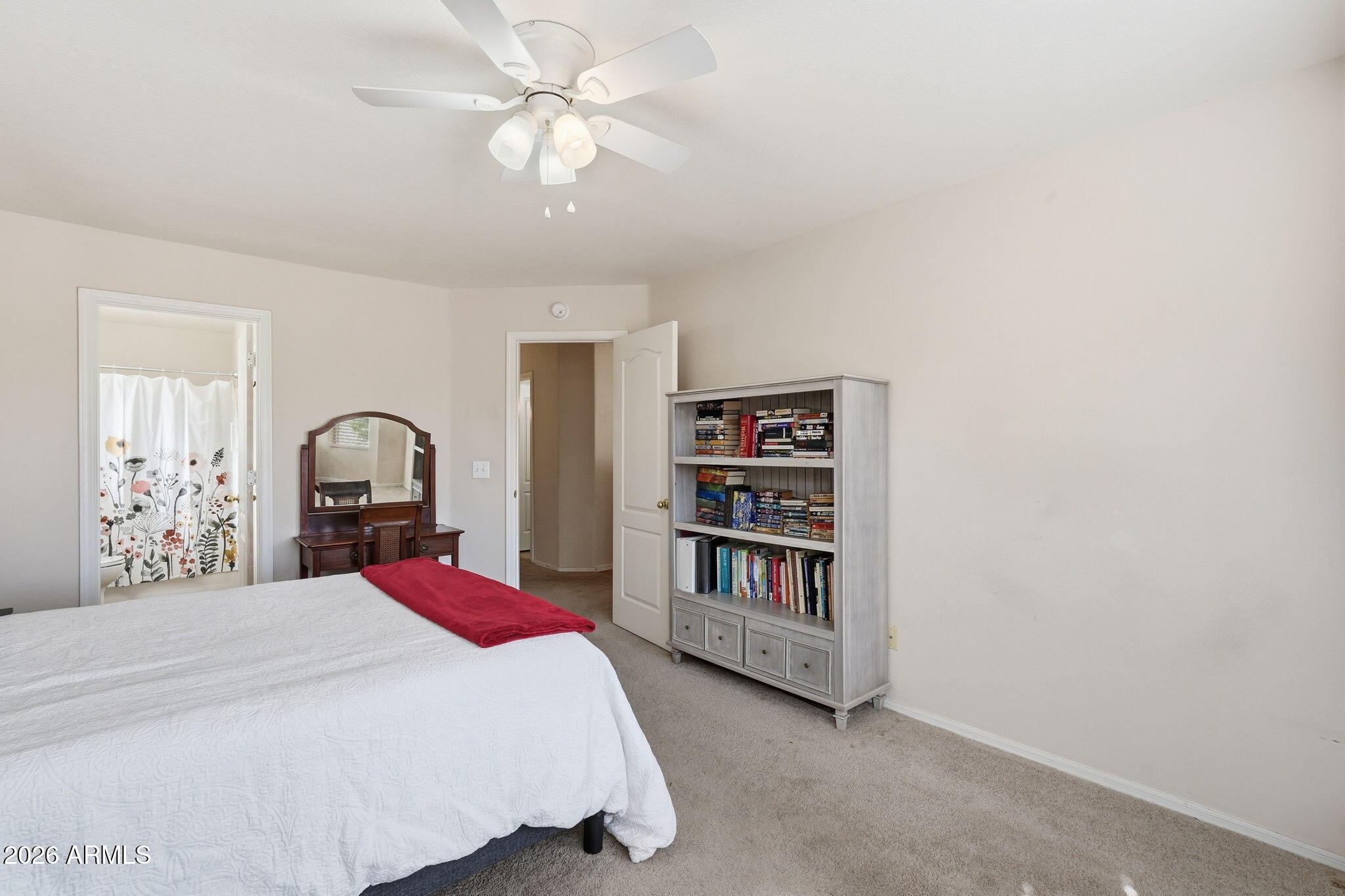 1405 West 15th Lane Apache Junction, AZ 85120 - Photo 20 of 33 a bedroom with a bed and a book shelf