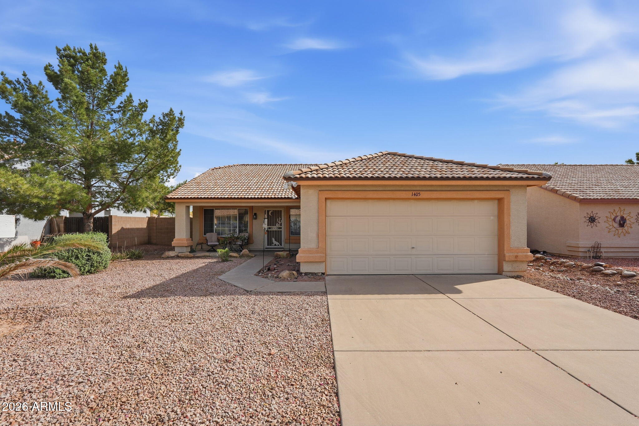 1405 West 15th Lane Apache Junction, AZ 85120 - Photo 2 of 33 a front view of a house with a yard and garage
