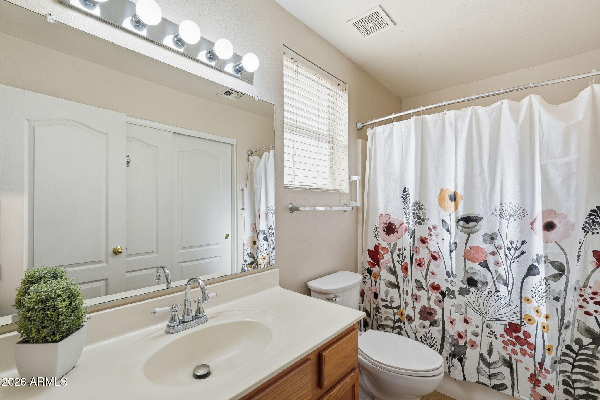 1405 West 15th Lane Apache Junction, AZ 85120 - Photo 22 of 33 a bathroom with a sink a toilet and a mirror