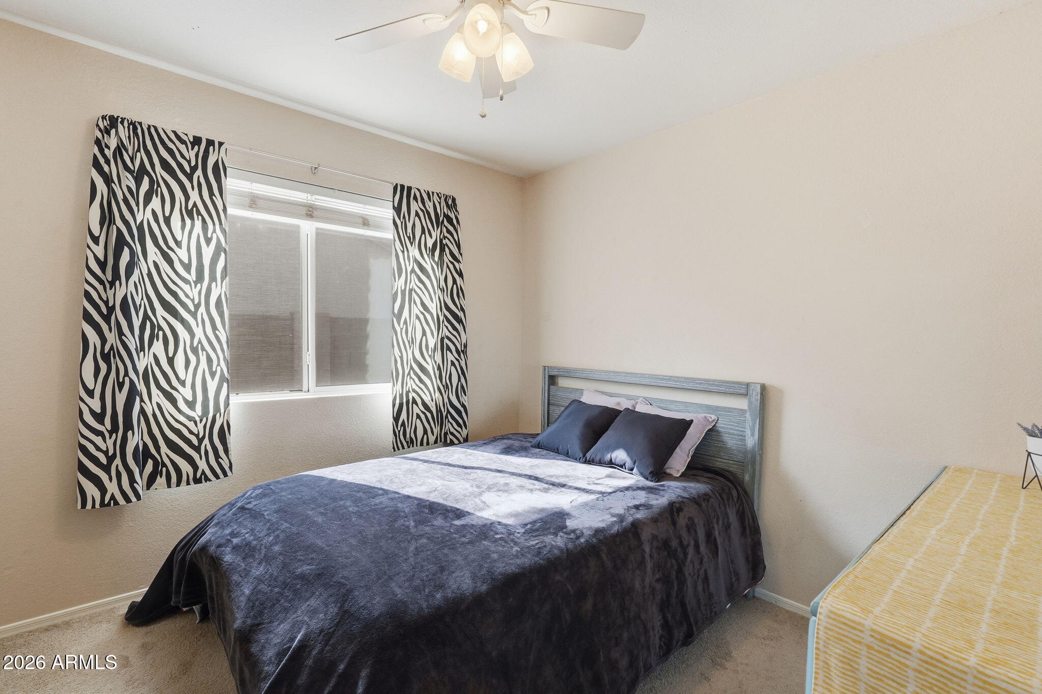 1405 West 15th Lane Apache Junction, AZ 85120 - Photo 23 of 33 a bedroom with a bed and a window