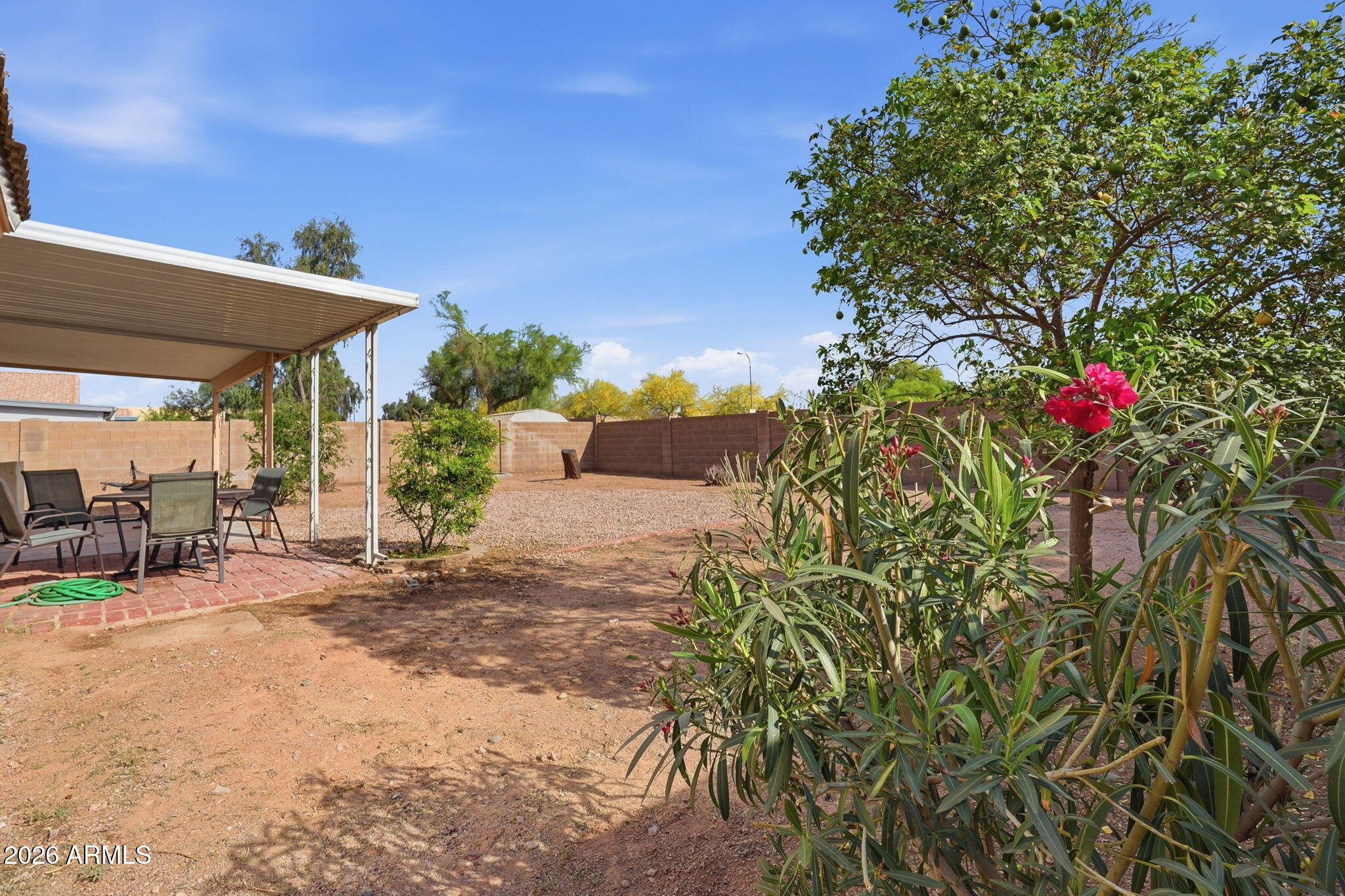 1405 West 15th Lane Apache Junction, AZ 85120 - Photo 32 of 33 a view of a patio with table and chairs under an umbrella