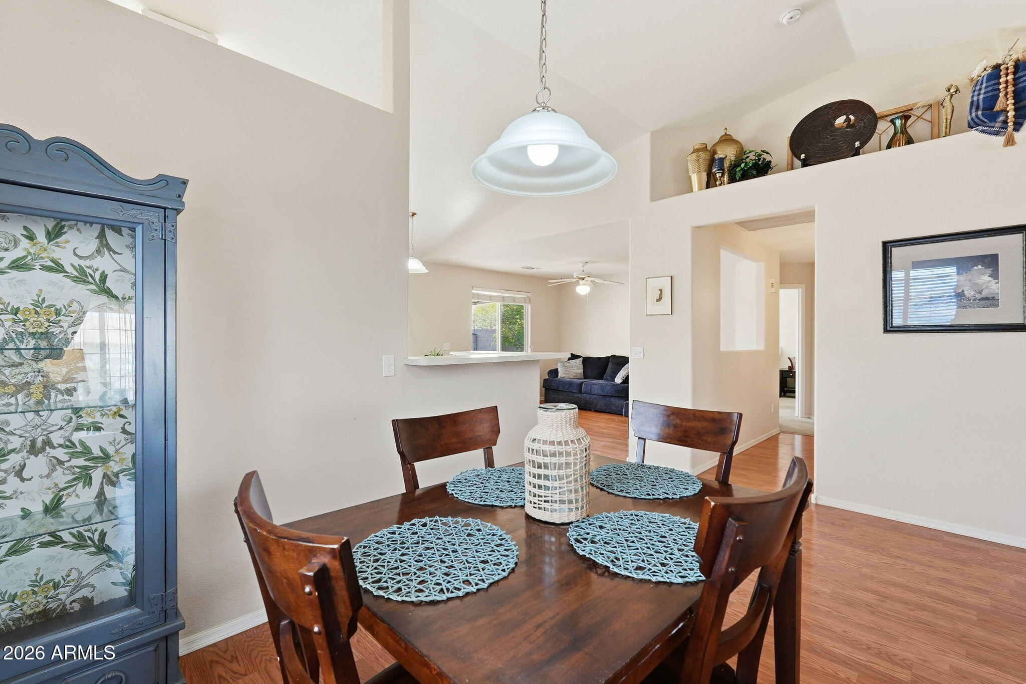 1405 West 15th Lane Apache Junction, AZ 85120 - Photo 10 of 33 a view of a dining room with furniture wooden floor and chandelier