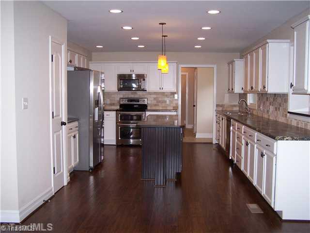 1067 Cantering Road High Point, NC 27262 - Photo 7 of 25 Kitchen. From the foyer coming straight ahead you enter in to the den and you have this view into the kitchen.