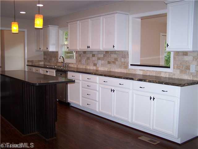 1067 Cantering Road High Point, NC 27262 - Photo 9 of 25 Kitchen. This view of the kitchen shows a pass through that leads to the breakfast room.