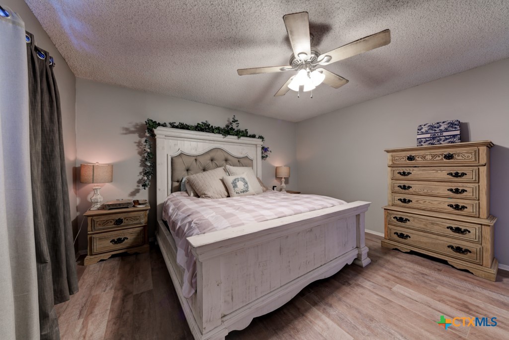 1229 Rapids Road New Braunfels, TX 78130 - Photo 12 of 27 a bedroom with a bed and a chandelier