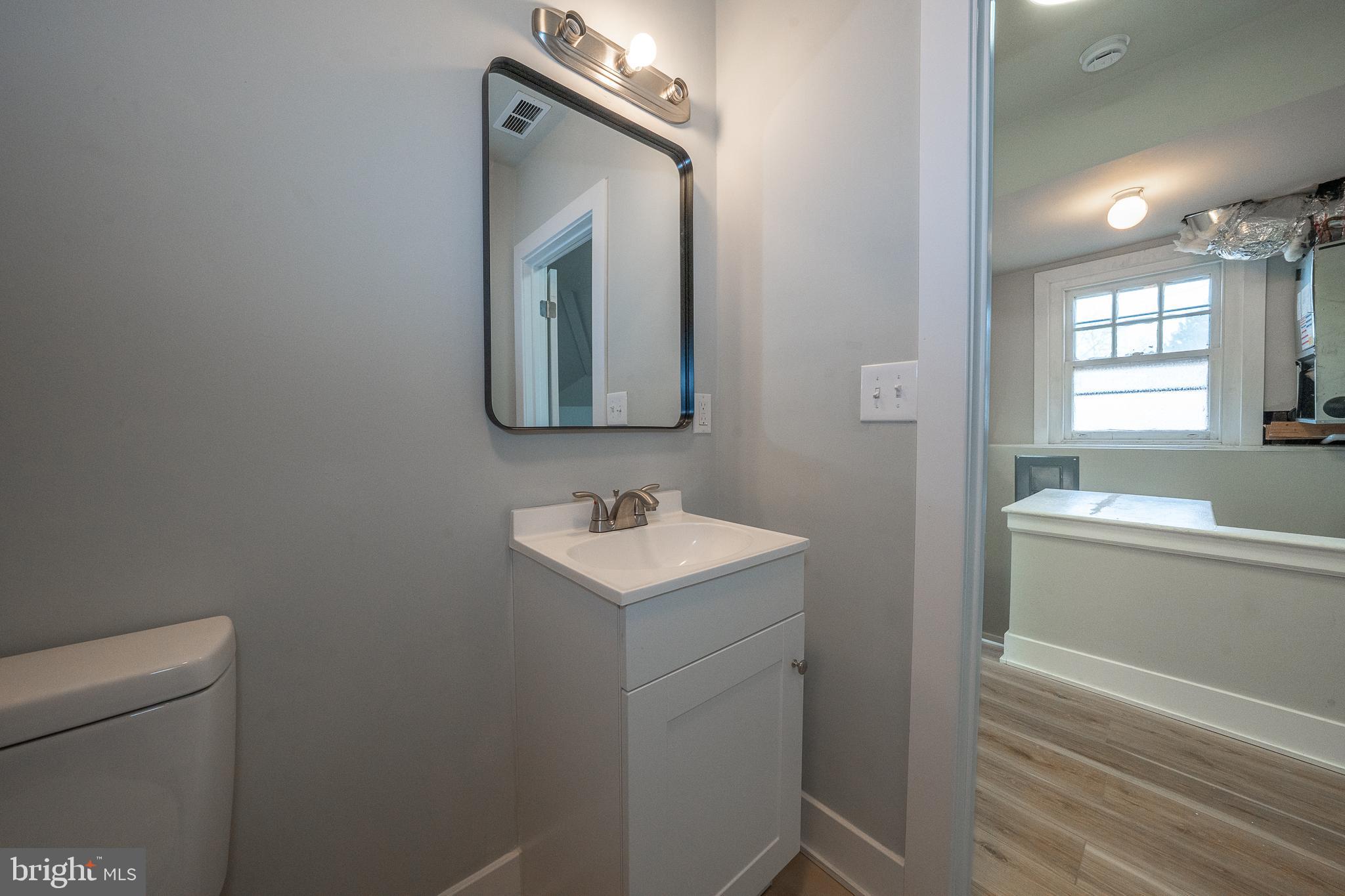 122 East 3rd Street, Unit 3 Pottstown, PA 19464 - Photo 11 of 35 a bathroom with a toilet sink and mirror