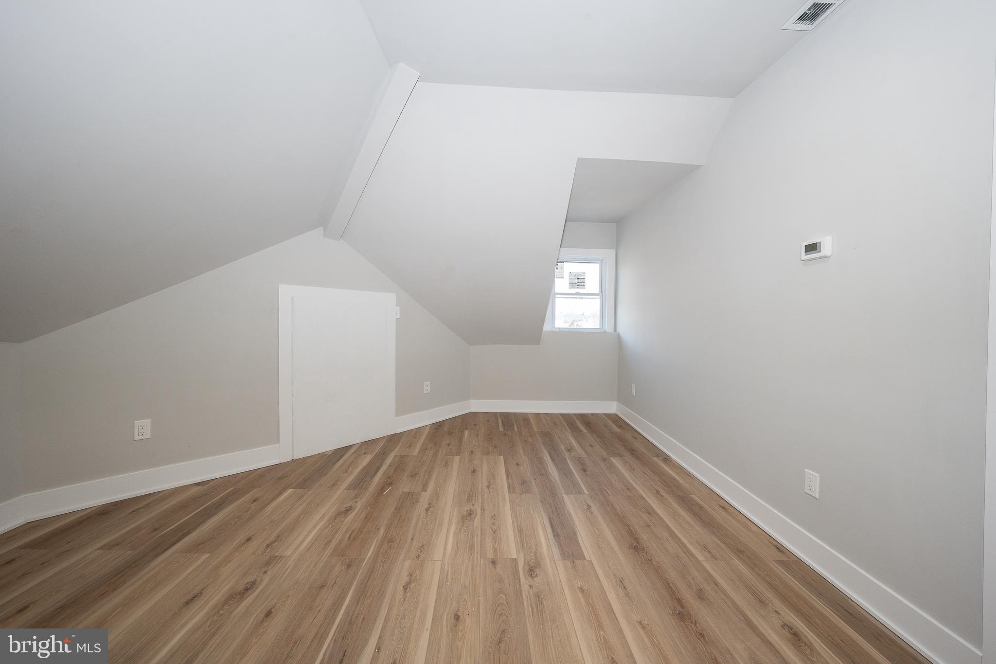 122 East 3rd Street, Unit 3 Pottstown, PA 19464 - Photo 21 of 35 an empty room with wooden floor and windows