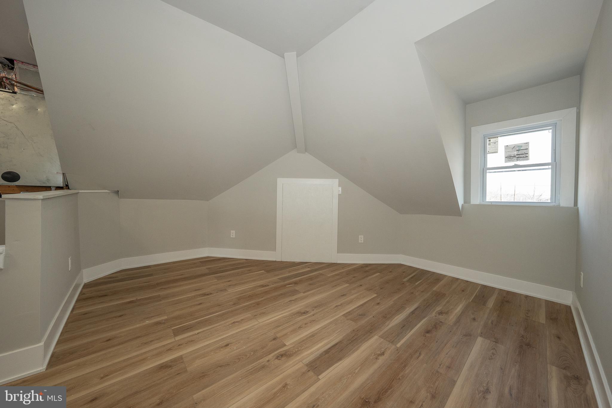 122 East 3rd Street, Unit 3 Pottstown, PA 19464 - Photo 27 of 35 a view of an empty room with wooden floor and a window