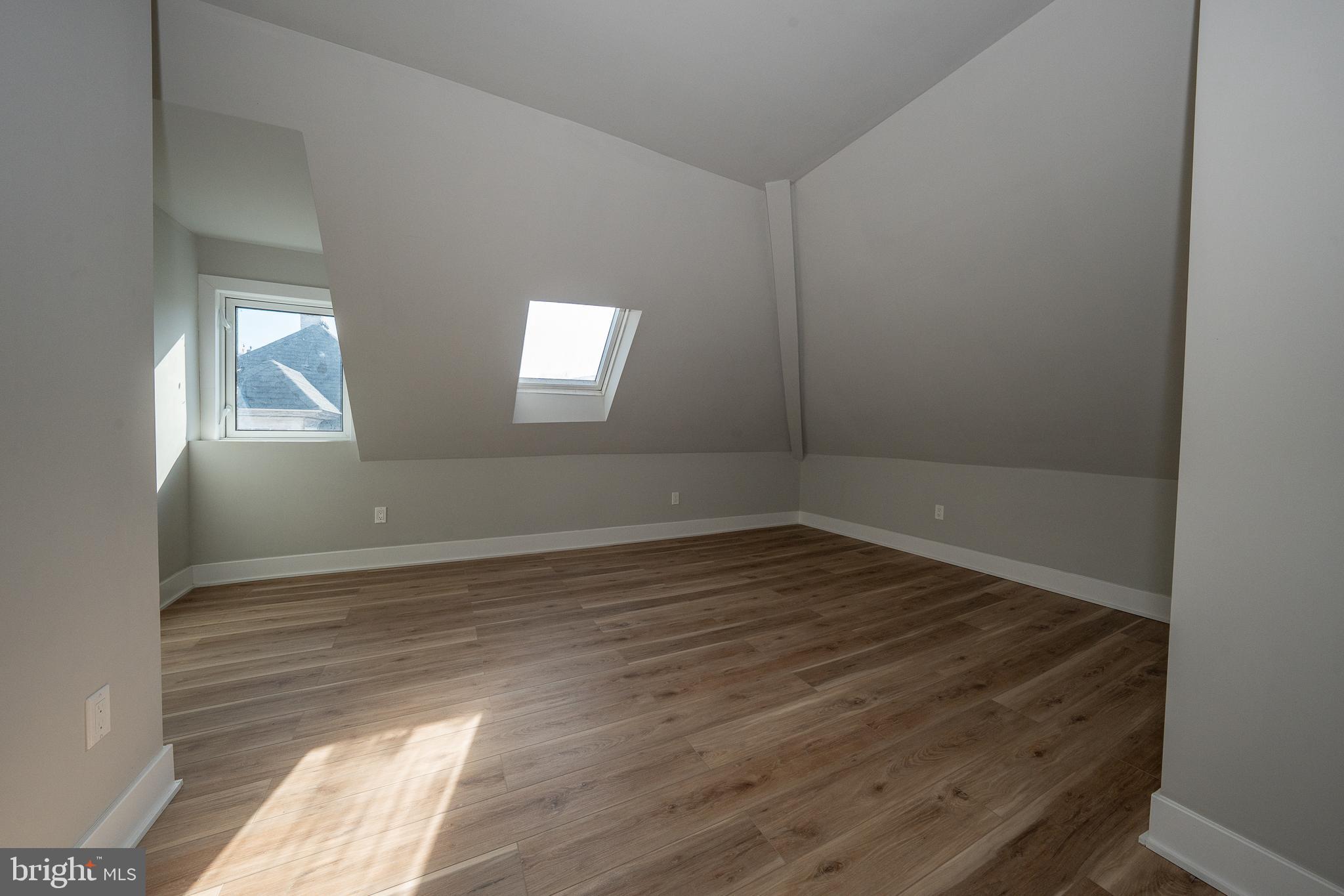 122 East 3rd Street, Unit 3 Pottstown, PA 19464 - Photo 28 of 35 an empty room with wooden floor and windows