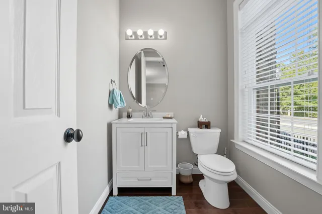 a bathroom with a toilet sink and mirror