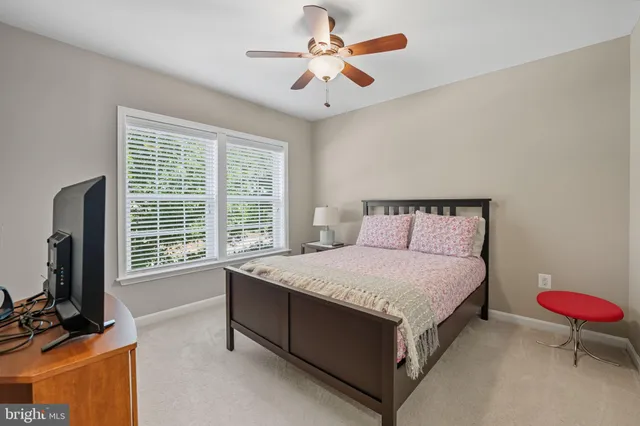 a bed room with a bed window and a flat screen tv