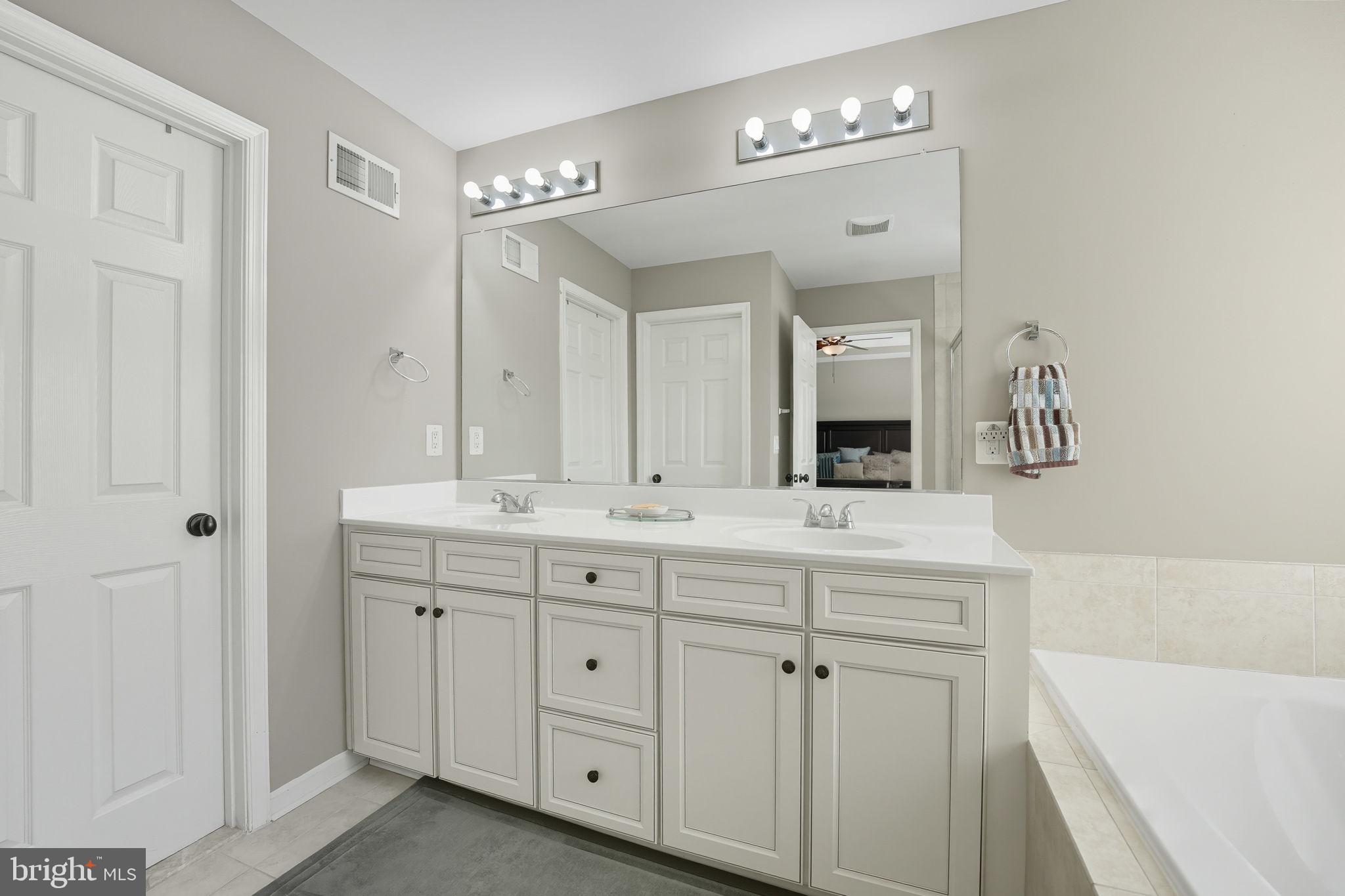4316 Chain Bridge Road Fairfax, VA 22030 - Photo 24 of 33 a bathroom with a double vanity sink mirror and bathtub