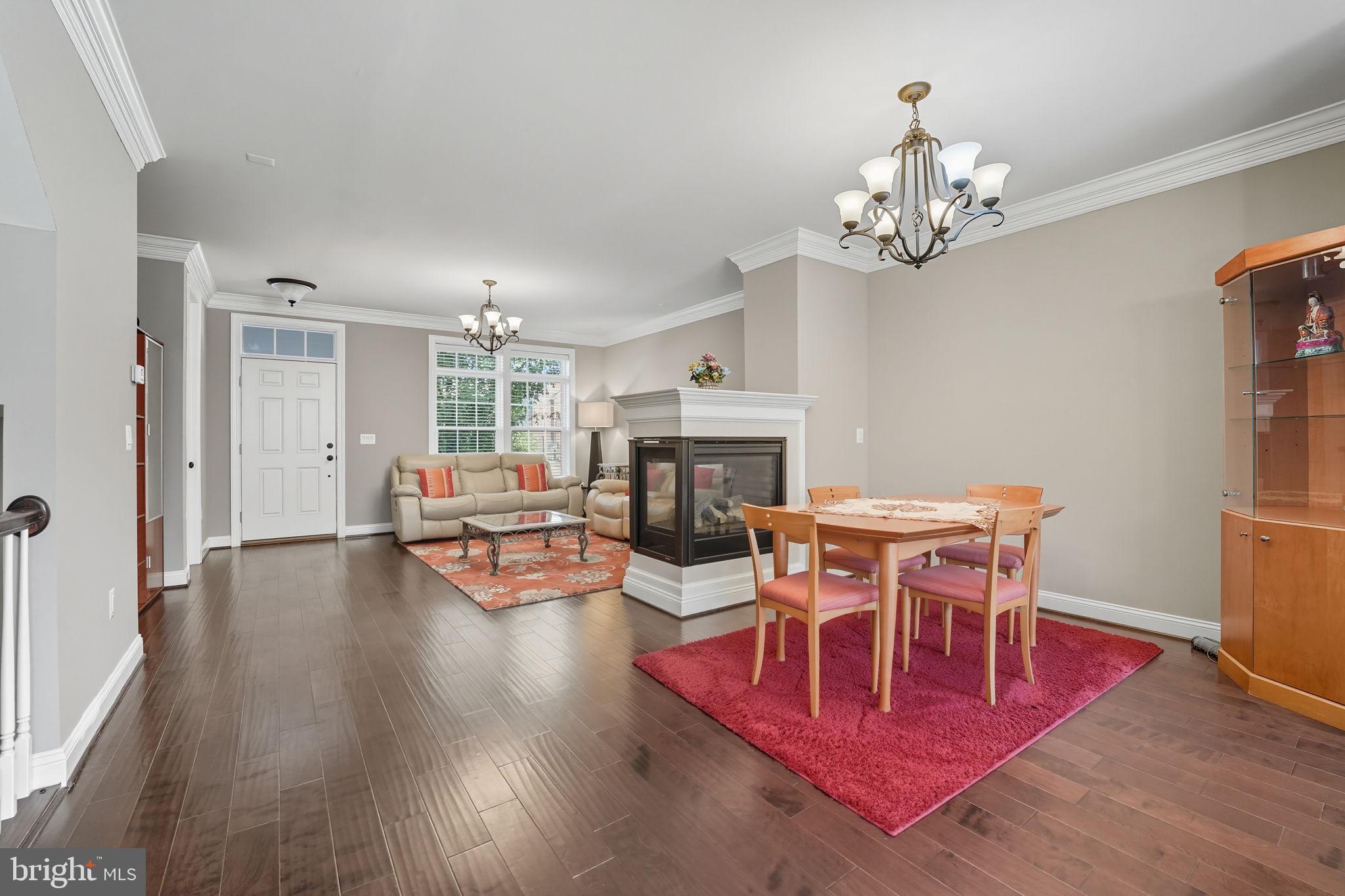 4316 Chain Bridge Road Fairfax, VA 22030 - Photo 6 of 33 a living room with fireplace furniture and a chandelier