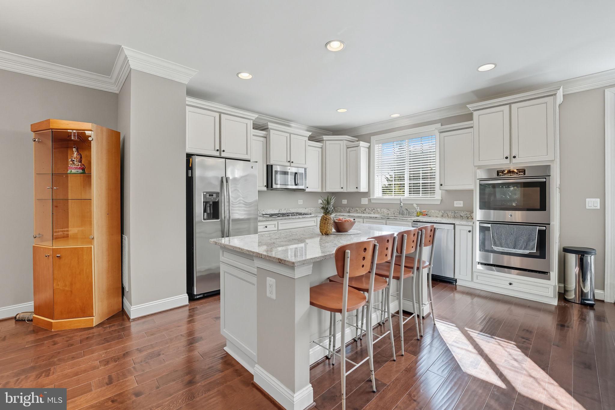 4316 Chain Bridge Road Fairfax, VA 22030 - Photo 7 of 33 a kitchen with stainless steel appliances granite countertop a refrigerator a stove top oven a sink and dishwasher