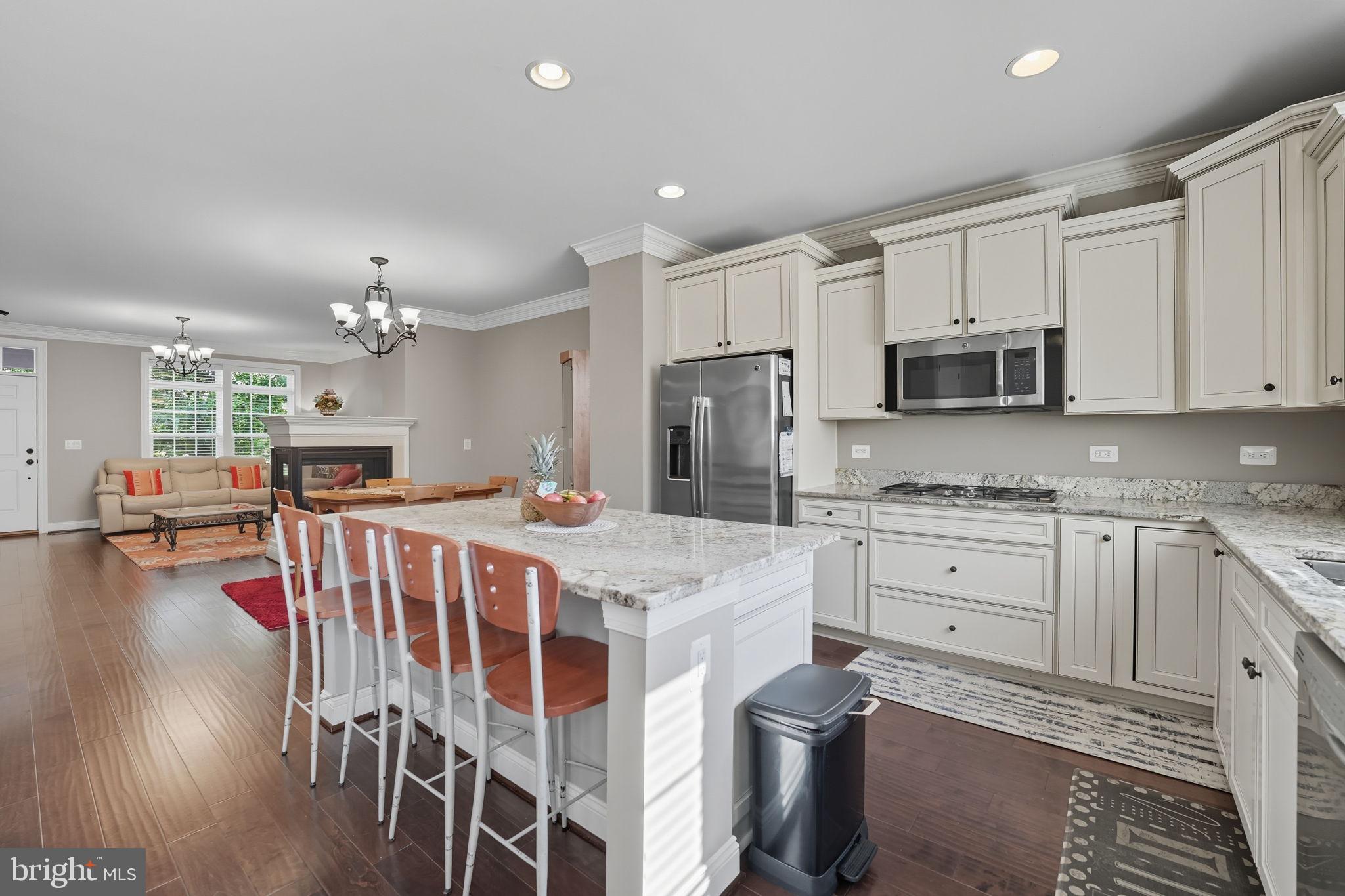 4316 Chain Bridge Road Fairfax, VA 22030 - Photo 8 of 33 a kitchen with kitchen island a stove a sink a refrigerator and cabinets