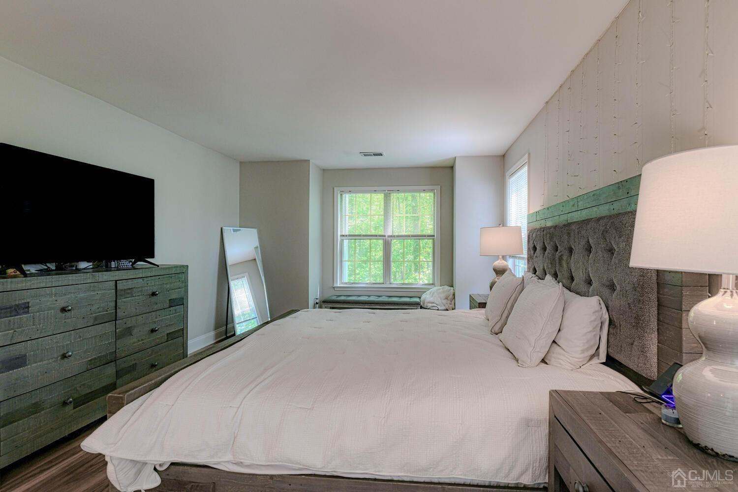307 Raintree Court Helmetta, NJ 08828 - Photo 8 of 24 a bedroom with a bed and a flat screen tv