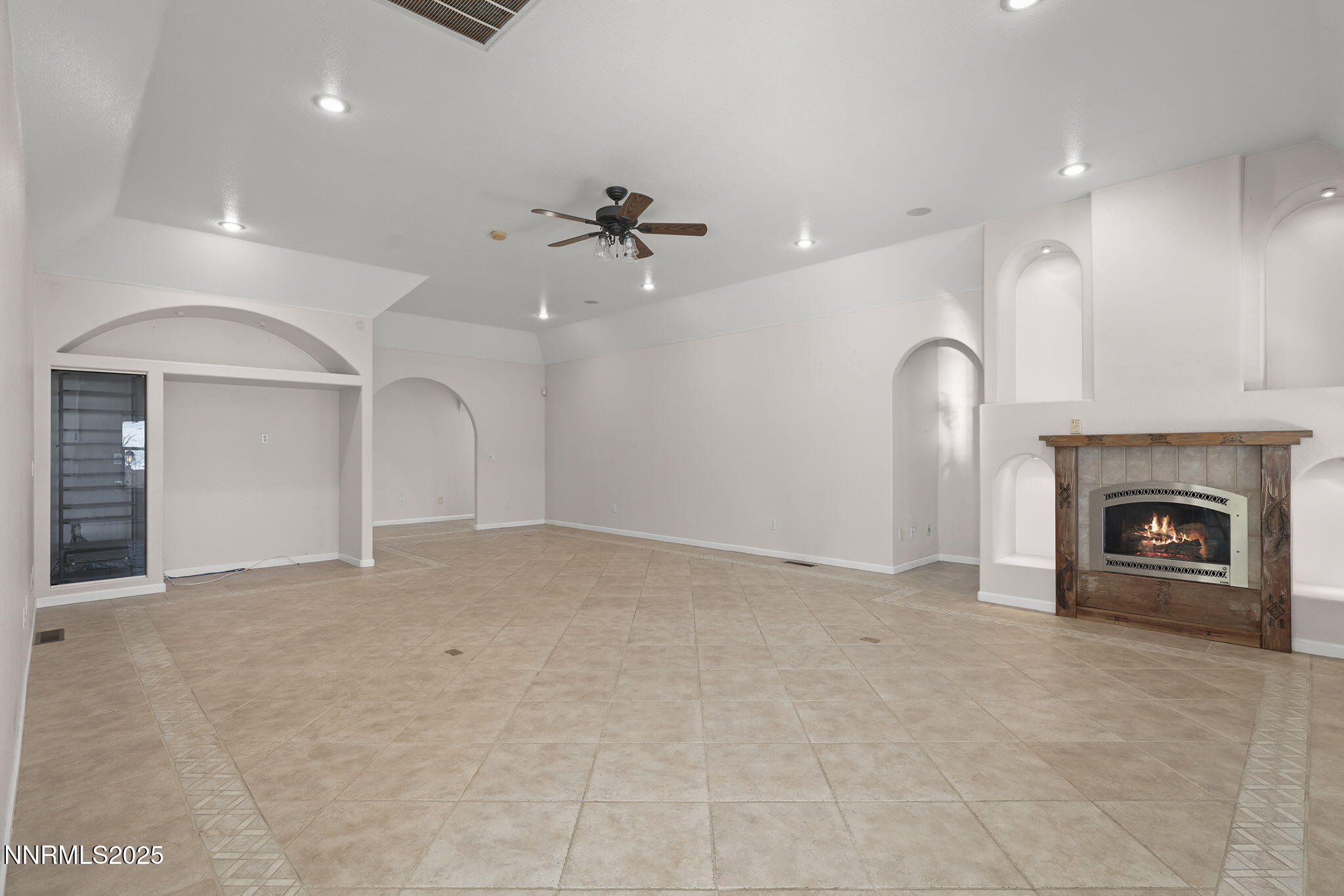 5700 Twin Springs Road Reno, NV 89510 - Photo 7 of 48 an empty room with a fireplace and fan