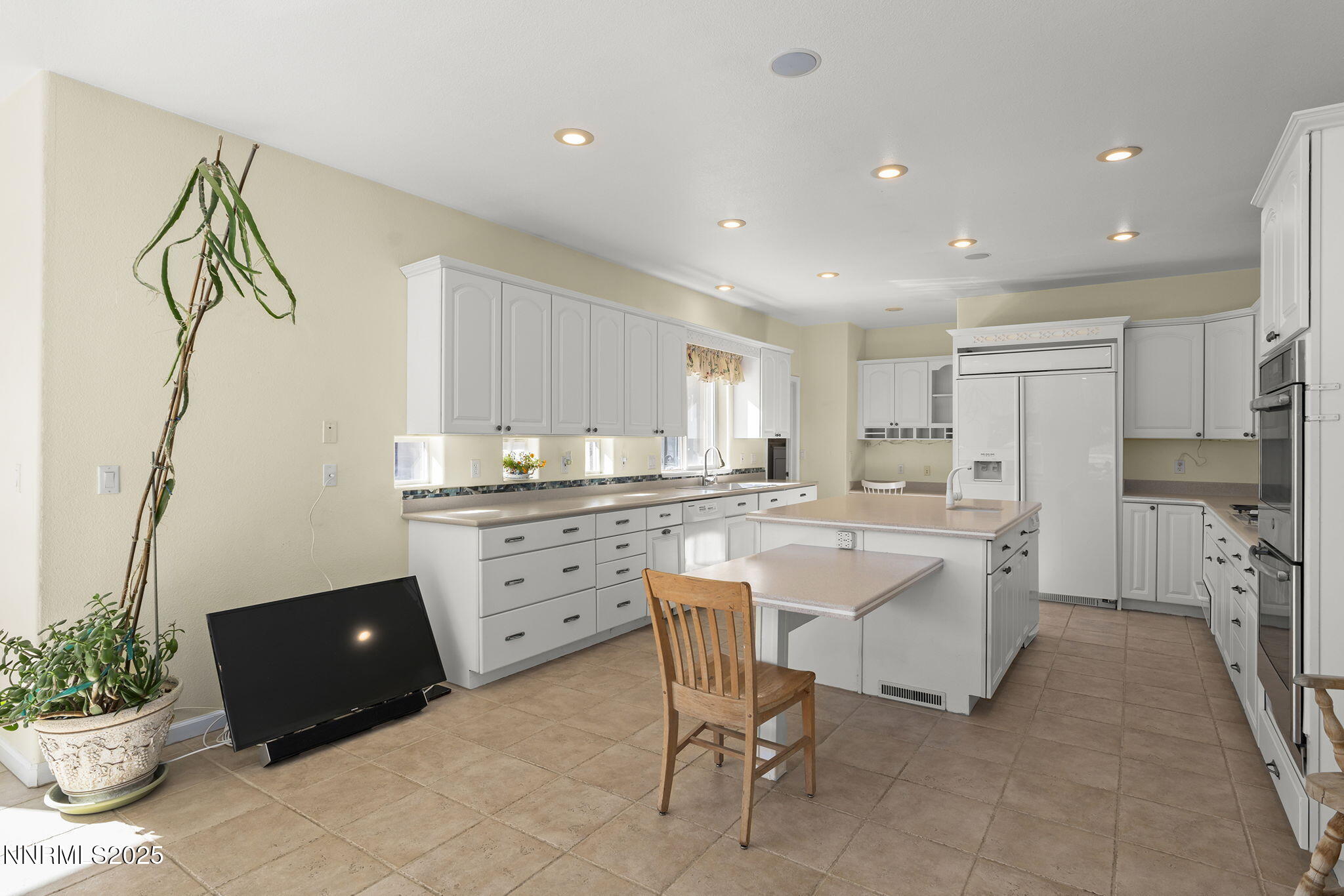 5700 Twin Springs Road Reno, NV 89510 - Photo 9 of 48 a kitchen with white cabinets and refrigerator