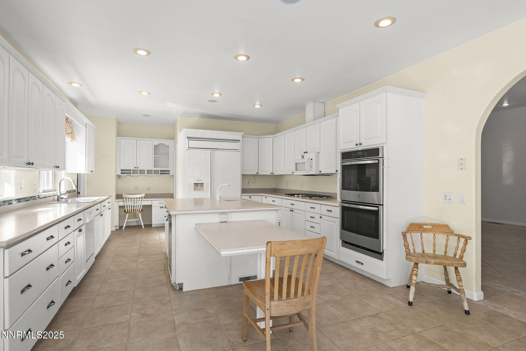 5700 Twin Springs Road Reno, NV 89510 - Photo 10 of 48 a large kitchen with kitchen island white cabinets and stainless steel appliances