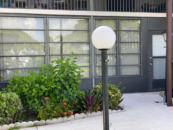 a front view of a house with a garden and plants