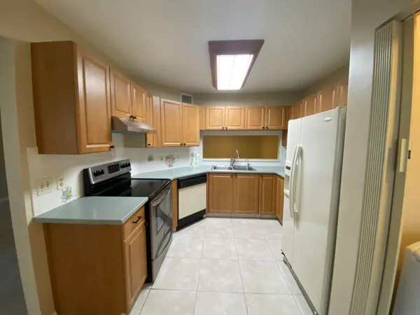 a kitchen with stainless steel appliances granite countertop a refrigerator sink and cabinets