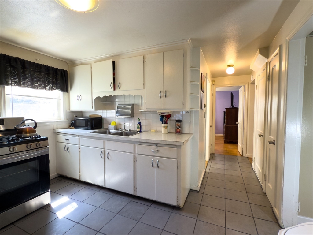 27 Cranmore Road Boston, MA 02136 - Photo 12 of 29 a kitchen with cabinets and appliances