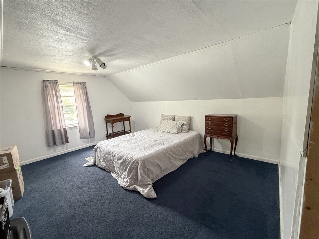27 Cranmore Road Boston, MA 02136 - Photo 18 of 29 a spacious bedroom with a bed table and window